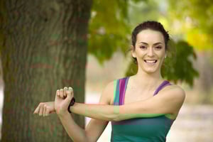Beautiful young woman stretching and warming up before a run