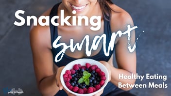 A smiling woman in a black sports bra holds a white bowl filled with fresh raspberries and blueberries, garnished with a sprig of mint. The text 